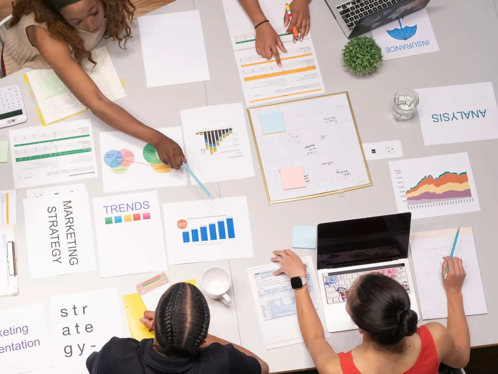 Strategy papers and charts spread on a desk